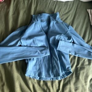 Light blue halara cropper zip up, never worn. SIZE- XS